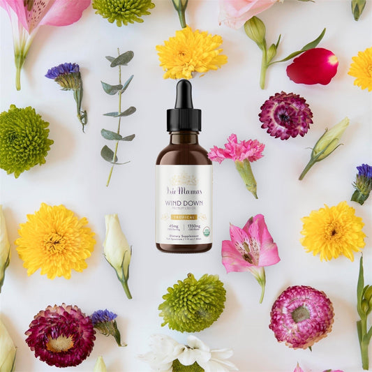 A photoshopped image of beautiful spring flowers. In the center is an Irie Mamas 1350mg Wind Down tincture.