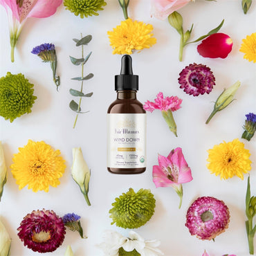 A photoshopped image of beautiful spring flowers. In the center is an Irie Mamas 1350mg Wind Down tincture.