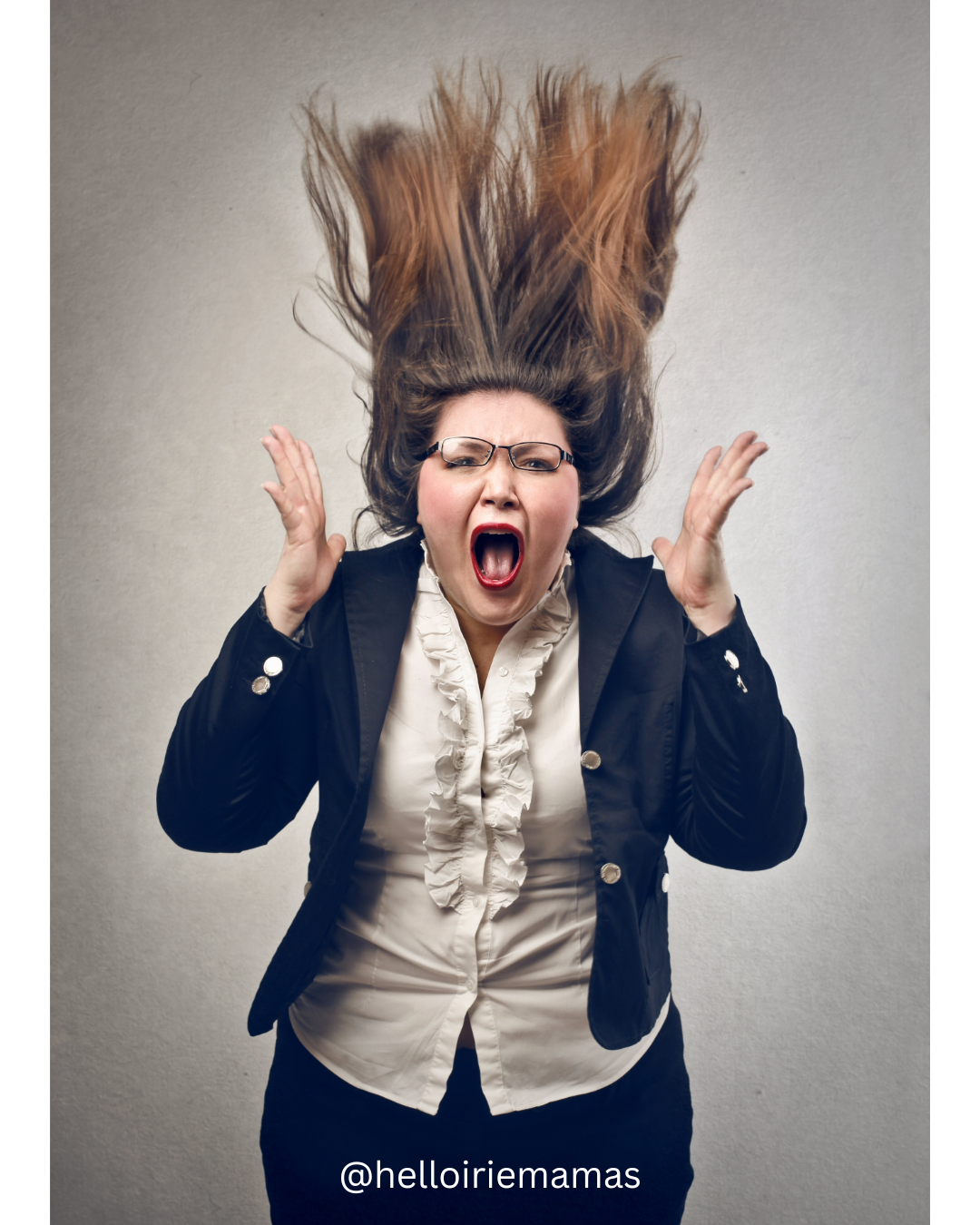 Image of woman screaming. Her hair and hands are in the air. 